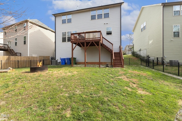 back of property with a wooden deck, a yard, a fenced backyard, stairs, and central air condition unit