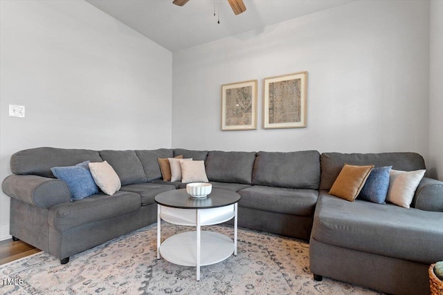 living area with wood finished floors and ceiling fan