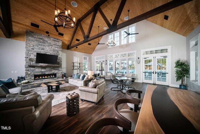 living room with a stone fireplace, french doors, wooden ceiling, and wood finished floors