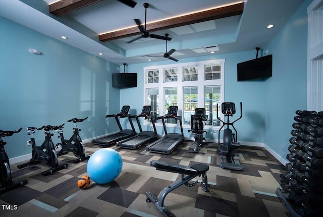 exercise room with a raised ceiling, recessed lighting, a ceiling fan, and baseboards