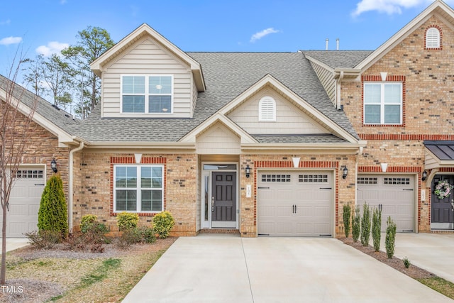 view of front of home with driveway, a garage, brick siding, and roof with shingles