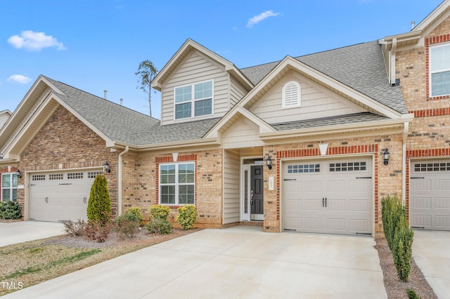 view of front of house featuring brick siding, driveway, a shingled roof, and an attached garage