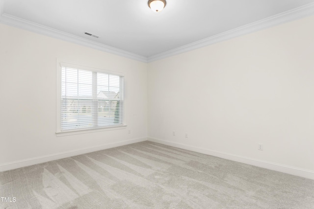 empty room with baseboards, light carpet, visible vents, and ornamental molding