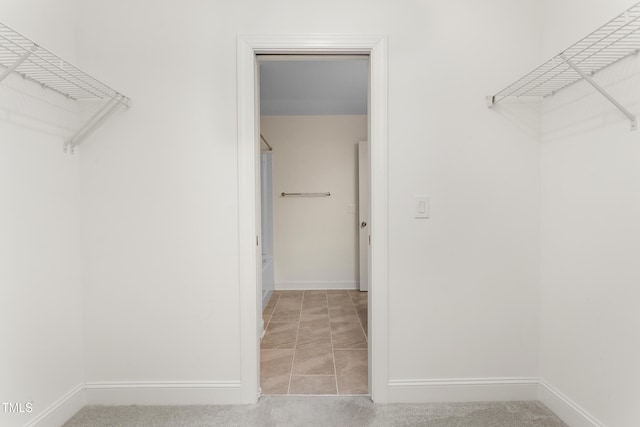 spacious closet with carpet flooring