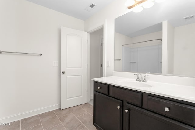 bathroom featuring tile patterned floors, visible vents, baseboards, and vanity