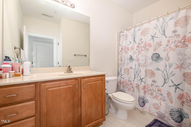 bathroom with toilet, tile patterned floors, visible vents, and vanity