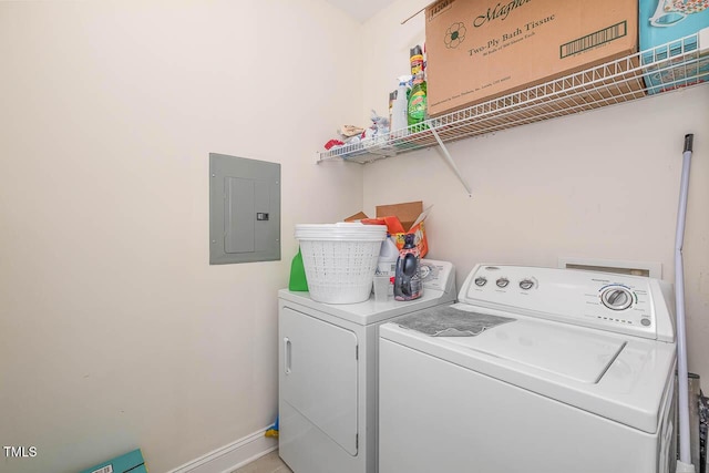 laundry room featuring laundry area, electric panel, washer and clothes dryer, and baseboards