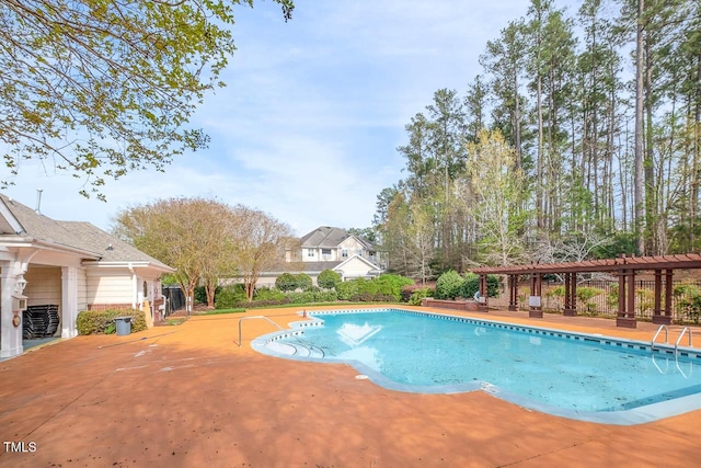 pool with a patio area and a pergola