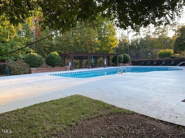 pool featuring a pergola and a patio