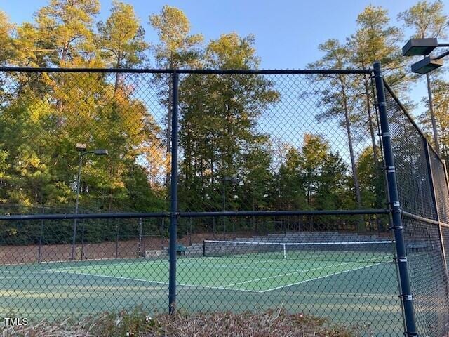 view of tennis court with fence