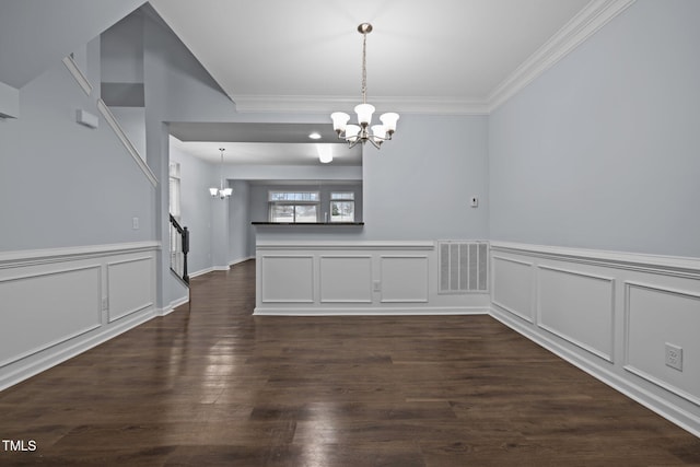 unfurnished dining area featuring a chandelier, dark wood-type flooring, ornamental molding, and visible vents