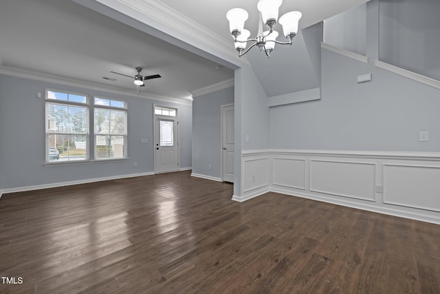 unfurnished room with crown molding, visible vents, a decorative wall, dark wood-type flooring, and ceiling fan with notable chandelier