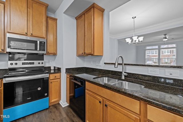 kitchen featuring dark wood-style flooring, dark stone countertops, stainless steel appliances, crown molding, and a sink