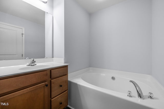 bathroom featuring vanity and a bath