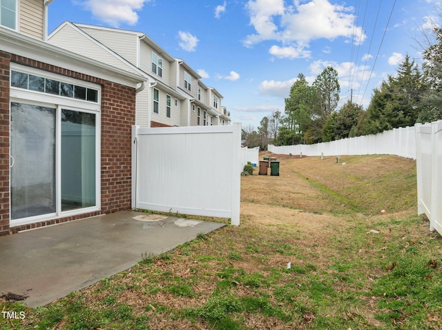 view of yard with fence and a patio