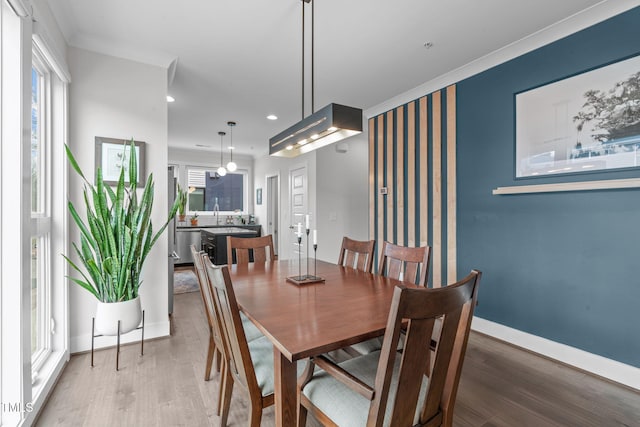 dining room with recessed lighting, baseboards, and wood finished floors