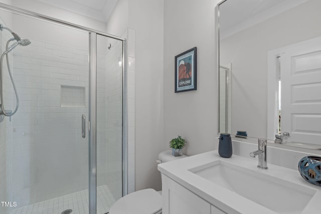 full bath with vanity, toilet, ornamental molding, and a shower stall