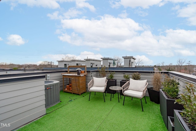 view of patio featuring a balcony and central AC unit