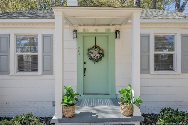 entrance to property with a shingled roof