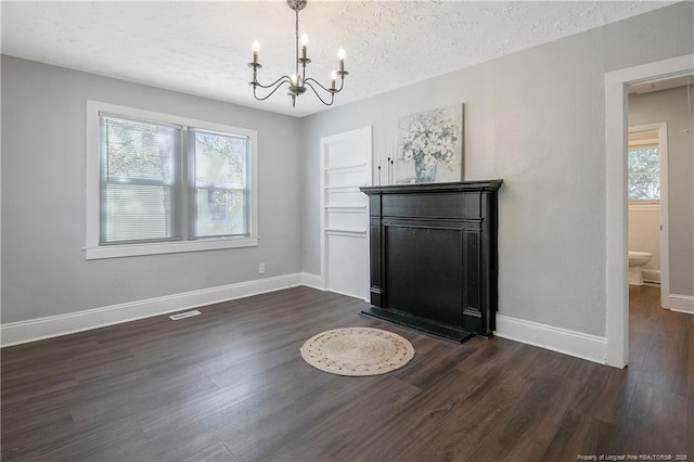 interior space featuring dark wood-style floors, a textured ceiling, and a wealth of natural light