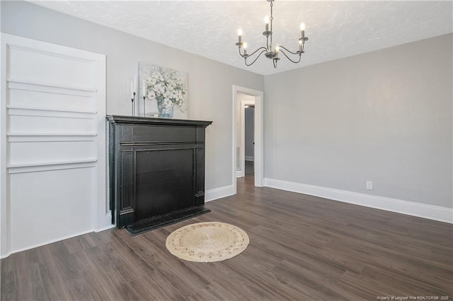 interior space featuring dark wood-style floors, a chandelier, and baseboards