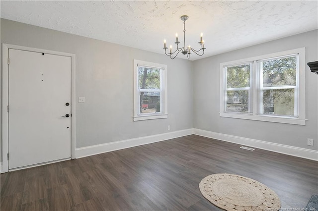 interior space featuring a wealth of natural light, baseboards, and wood finished floors