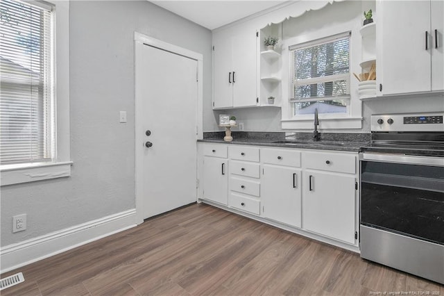 kitchen featuring electric range, a sink, white cabinetry, open shelves, and dark wood finished floors