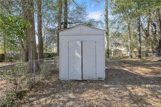 view of shed with a fenced backyard