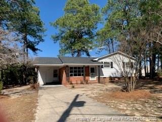 tri-level home featuring a carport and concrete driveway