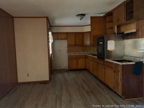 830 Dinmont Cir, Fayetteville, NC 28306 - kitchen with light wood-style flooring, light countertops, black appliances, brown cabinets, and open shelves