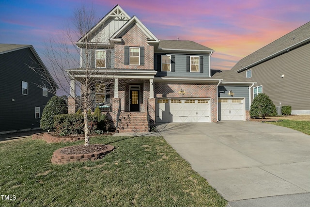 view of front of house featuring driveway, covered porch, a front lawn, and brick siding