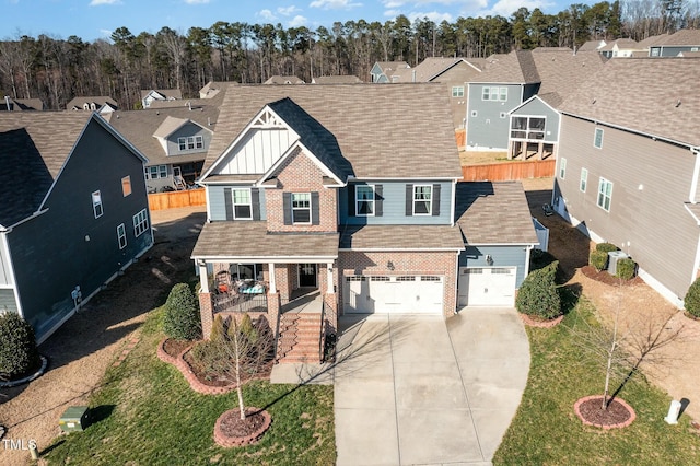 view of front of house with board and batten siding, a residential view, covered porch, and driveway