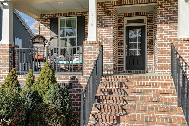 doorway to property with brick siding