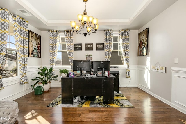 office area with a tray ceiling, wainscoting, a decorative wall, and hardwood / wood-style floors