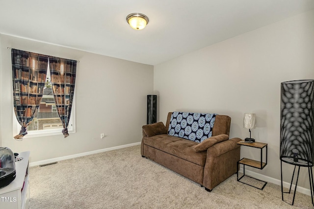 sitting room with baseboards, visible vents, and carpet flooring