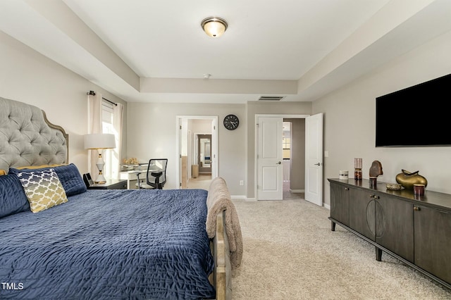 bedroom featuring a raised ceiling, visible vents, light carpet, and baseboards