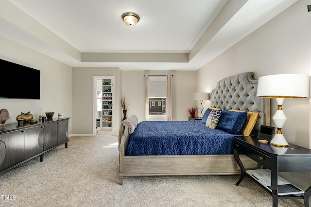 bedroom featuring baseboards, a raised ceiling, and carpet flooring