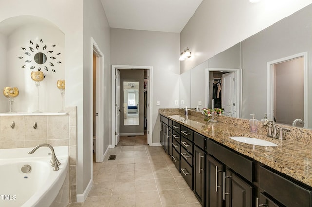 full bathroom with a bath, visible vents, a sink, and tile patterned floors