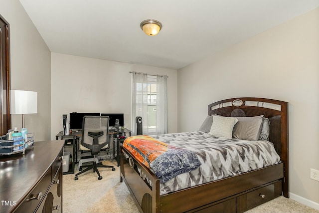 bedroom featuring light colored carpet and baseboards