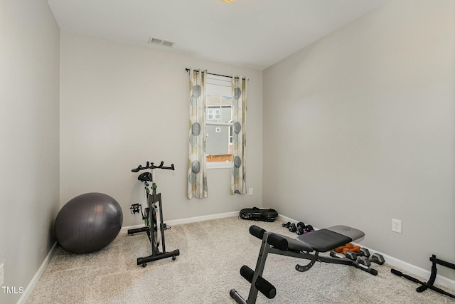 workout room featuring baseboards, visible vents, and carpet flooring