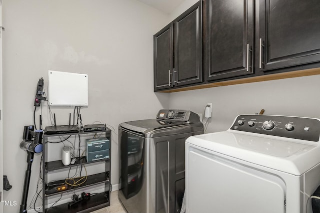 clothes washing area with cabinet space and independent washer and dryer