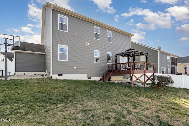 back of property with a lawn, a gazebo, crawl space, fence, and a wooden deck