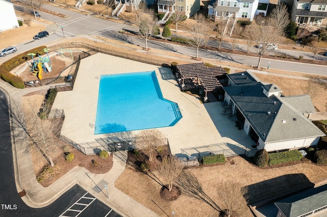 view of pool with a residential view and fence