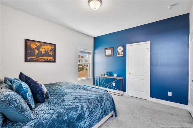 bedroom with carpet and baseboards