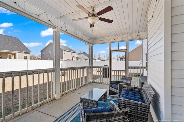 exterior space with outdoor lounge area, a fenced backyard, a residential view, and ceiling fan