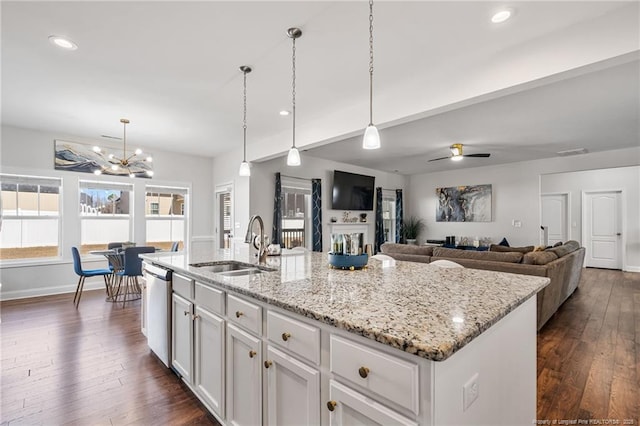 kitchen featuring light stone counters, dark wood finished floors, white cabinetry, and dishwasher