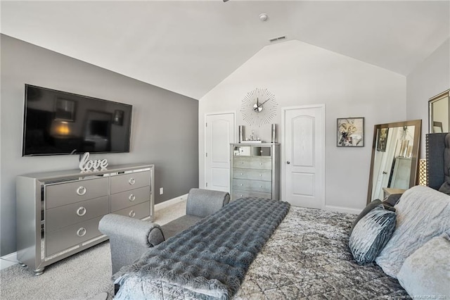 carpeted bedroom with visible vents, vaulted ceiling, and baseboards