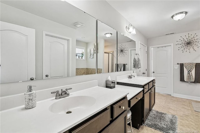 full bath with visible vents, a shower stall, vanity, baseboards, and tile patterned floors