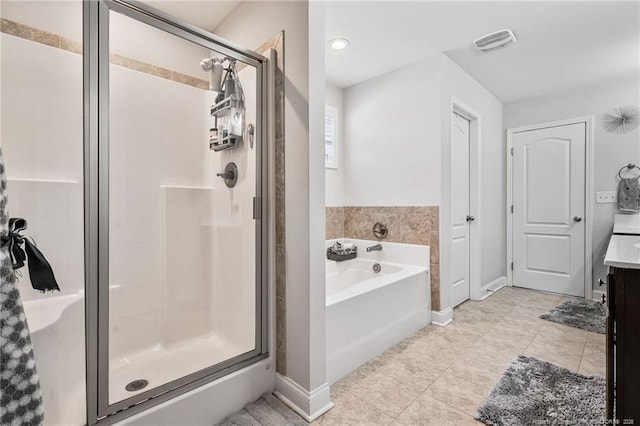 bathroom with a stall shower, visible vents, a garden tub, tile patterned flooring, and vanity