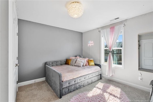 carpeted bedroom with visible vents and baseboards